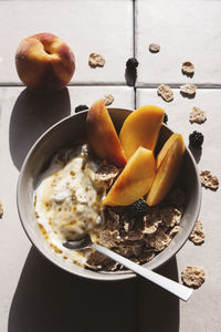 Healthy breakfast. overhead shot of bowl with oatmeals peach and yogurt. 