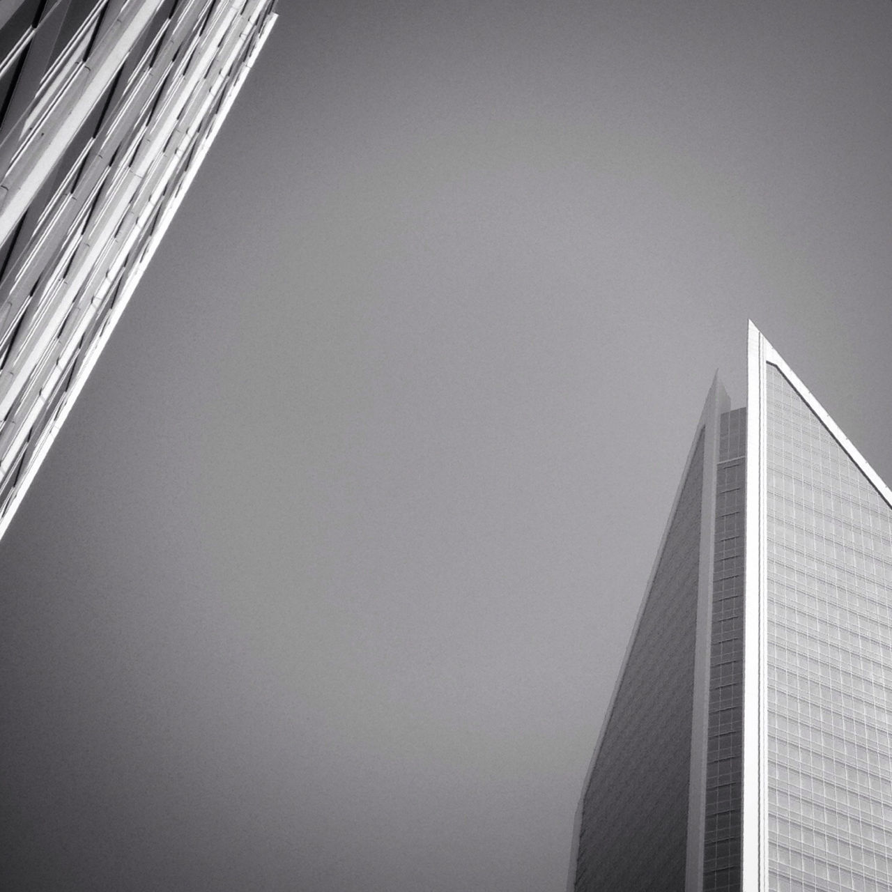 architecture, built structure, low angle view, building exterior, copy space, clear sky, building, modern, city, office building, sky, skyscraper, outdoors, tall - high, no people, day, high section, window, directly below, glass - material