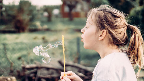 Side view of girl holding outdoors