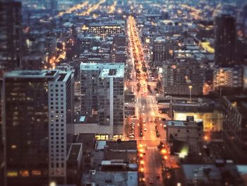 High angle view of city lit up at night