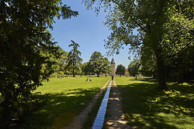 Footpath in park against sky