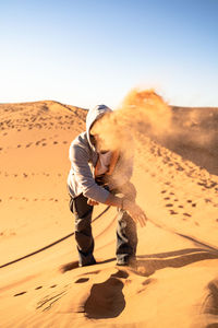 Full length of a horse on sand