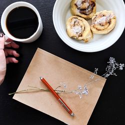 High angle view of coffee and notebook on table