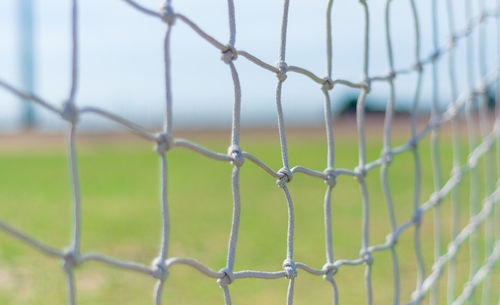 Close-up of chainlink fence against sky