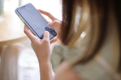 Midsection of woman using mobile phone