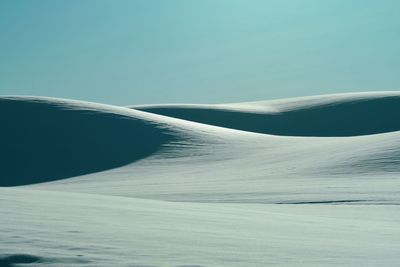 Scenic view of snowcapped landscape against clear sky