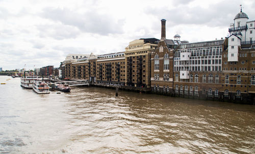 View of boats in river with buildings in background