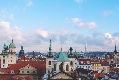 View of cityscape against cloudy sky