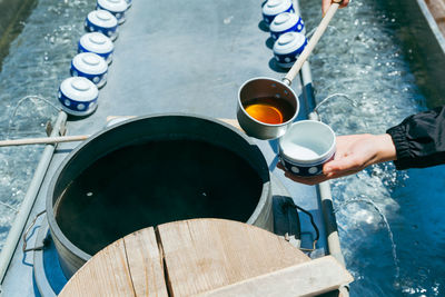 Hot tea being served from a traditional outdoor tea pot