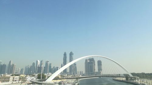 Low angle view of bridge in city against clear sky