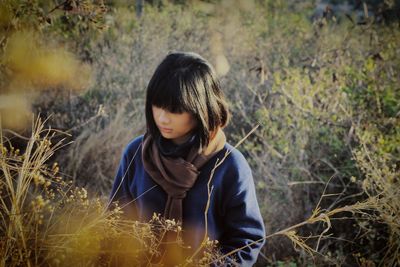 Woman with bangs standing on field