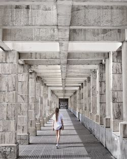 Rear view of woman walking on bridge