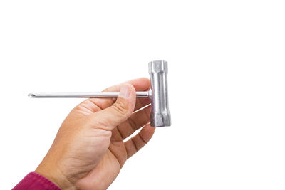 Close-up of hand holding machine against white background