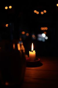 Close-up of illuminated candle at night
