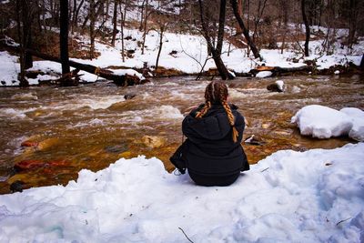 Rear view of woman on snow covered land