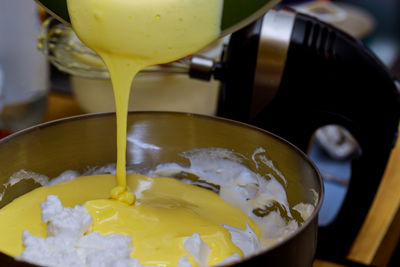 Close-up of yellow pouring drink in bowl