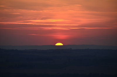 Scenic view of silhouette landscape against romantic sky at sunset