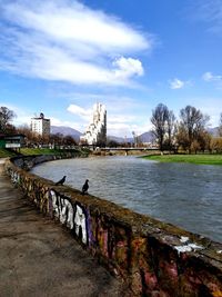 View of river in city against sky