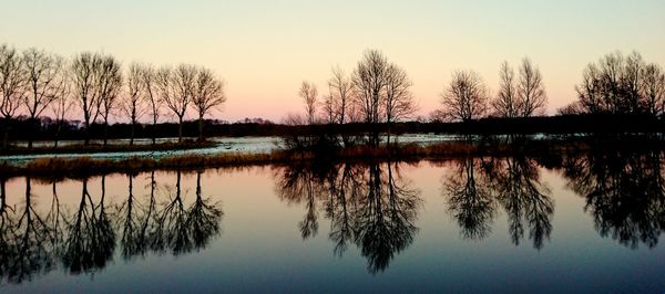 Scenic view of lake against sky during sunset