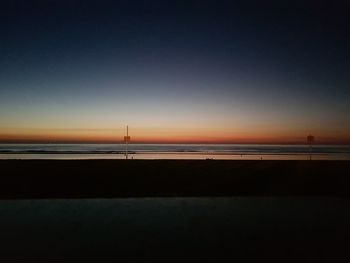 Scenic view of sea against clear sky at sunset