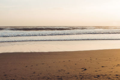 Scenic view of beach against sky during sunset