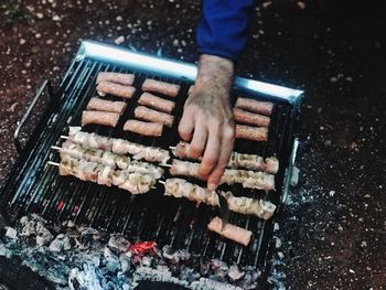 High angle view of person preparing food on barbecue grill