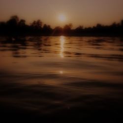 Scenic view of lake at sunset