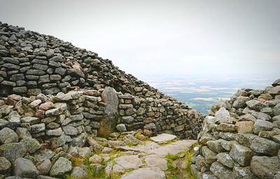 Stone wall with rocks in foreground