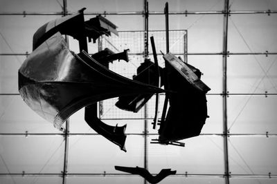 Low angle view of shoes hanging on metal against wall