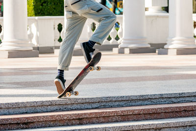 Low section of man skateboarding on skateboard