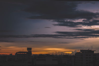 Silhouette buildings against sky during sunset