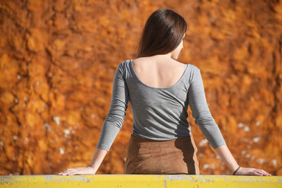 Woman standing by the wall