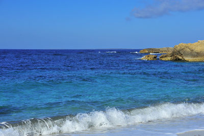 Scenic view of sea against clear blue sky