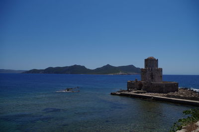 Scenic view of sea against clear blue sky