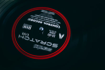 Close-up of illuminated red light against black background