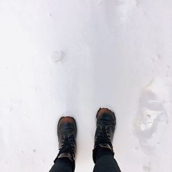 Low section of person standing in snow