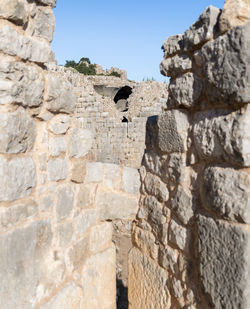 Low angle view of stone wall against sky