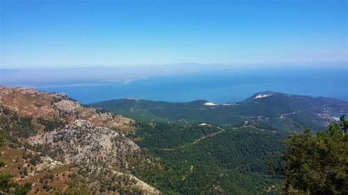 Scenic view of mountains against blue sky