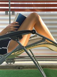 Low section of woman sitting on chair