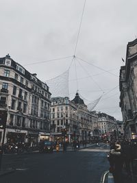 City street and buildings against sky