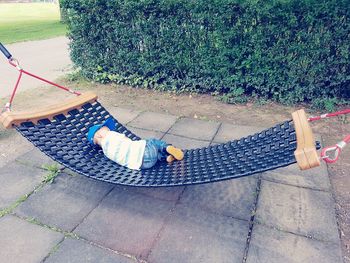 High angle view of girl sitting on grass at park