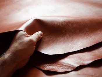 Close-up of human hand holding leather