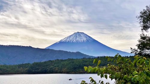 Scenic view of snowcapped mountain against cloudy sky