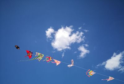 Low angle view of flag against blue sky