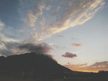 Scenic view of silhouette mountains against sky at sunset