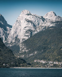 Scenic view of sea and mountains against sky