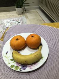 High angle view of fruits in plate on table