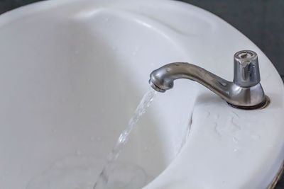 High angle view of water from faucet in bathroom