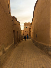 People walking on street amidst buildings in city