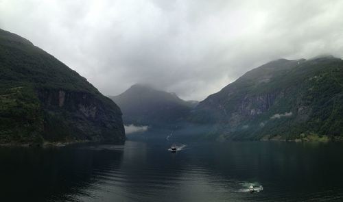 Scenic view of lake and mountains against sky